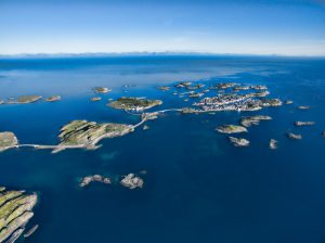 Aerial view of picturesque fishing port Henningsvaer on small islands in the sea